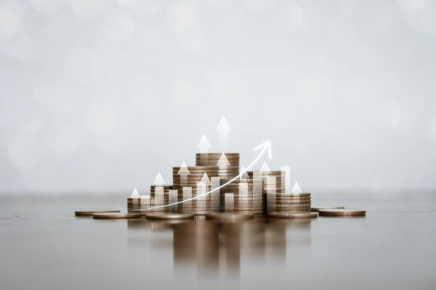 istock Stack of silver coins with an arrow pointing upwards with trading charts Concepts about finance, investing, interest, financial risk management, banking. 1939355151