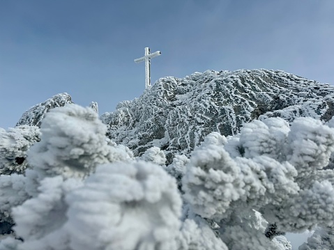 Ice covered mountain with summit cross