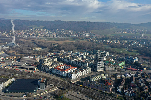 Dietikon is the fifth biggest city of the canton of Zürich. The image shows the Municipality with several residential buildings, captured during autumn season.
