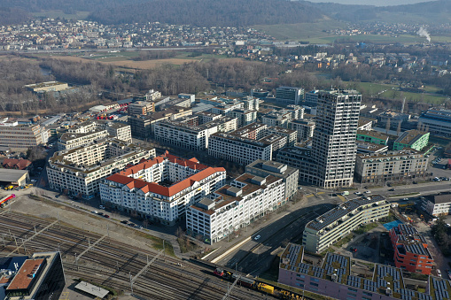 Dietikon is the fifth biggest city of the canton of Zürich. The image shows the Municipality with several residential buildings, captured during autumn season.