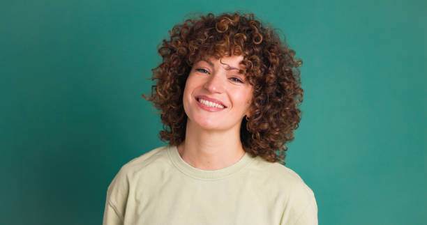 Smiling woman on green background stock photo
