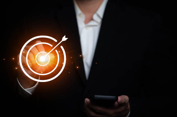 istock Business man point to target and success 1939435471