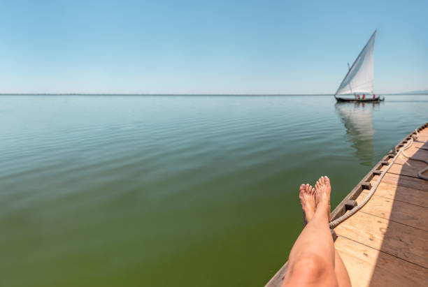 Tired legs on the boat with Mediterranean landscape