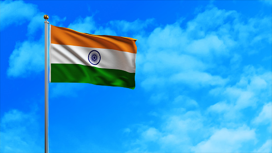 National Flag of India Against Defocused City Buildings