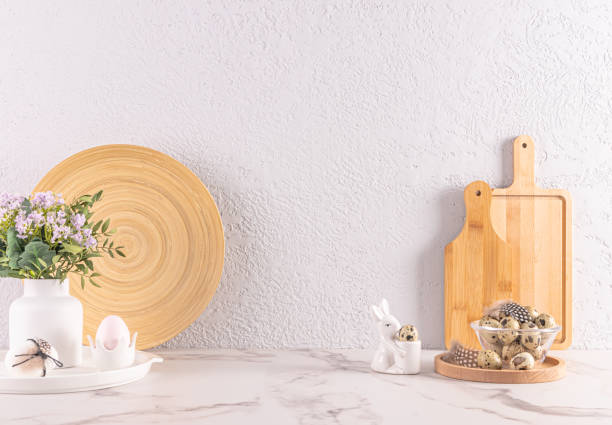 istock Festive decorations of kitchen stone countertop for Easter day. wooden kitchen utensils, ceramic bunny , vase of flowers. Eco-friendly kitchen. 1939464068
