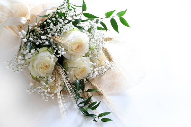 Elegant white roses and babies breath bouquet isolated on white background.Wedding, Valentine's day, birthday, mother's day, anniversary. Fresh flowers. Flat lay. Overhead view. Copy space.