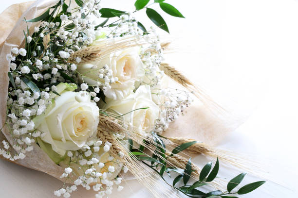 Elegant white roses and babies breath bouquet isolated on white background.Wedding, Valentine's day, birthday, mother's day, anniversary. Fresh flowers. Flat lay. Overhead view. Copy space.