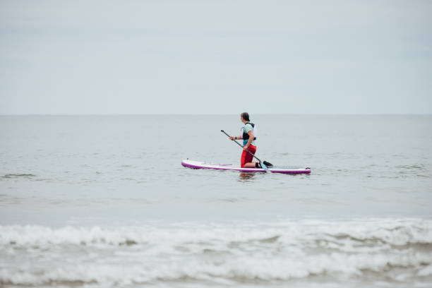 istock Woman Paddle Boarding at the Sea 1939500486