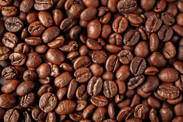 Top view of aromatic brown coffee beans lying on surface