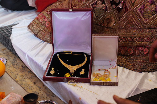 Closeup of real gold jewelry in box during wedding