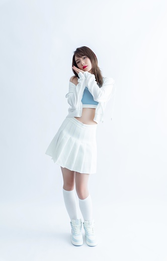 Young Asian woman in a white pleated skirt and crop top