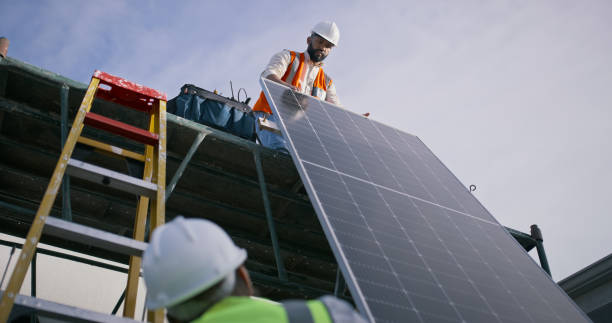 istock Solar panel, construction and men on roof for installation, maintenance and building infrastructure. Engineering, teamwork and electrician workers with renewable energy, electricity or sustainability 1939502974