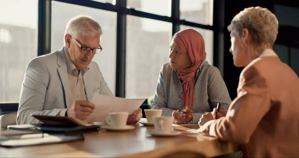istock Senior group, business people and meeting with diversity, document and discussion for project in conference room. Corporate team, market research and reading stats with info, collaboration and trust 1939503296