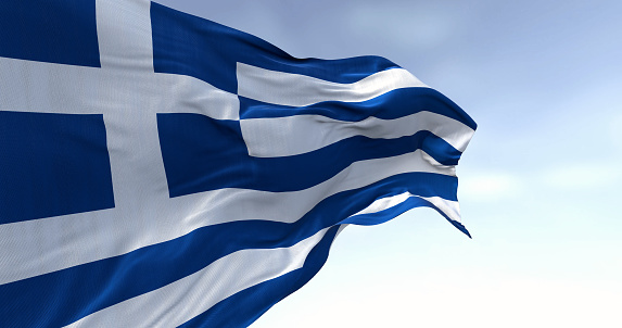 Close-up of national flag of Greece waving in the wind on a clear day. Blue and white stripes with a blue canton bearing a white cross. 3d illustration render. Fluttering fabric