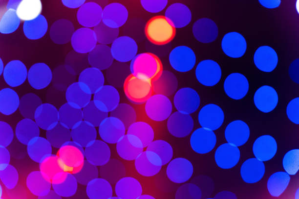Vibrant blue and red bokeh lights creating a festive and celebratory atmosphere against a dark background. Perfect for holiday-themed designs and concepts.
