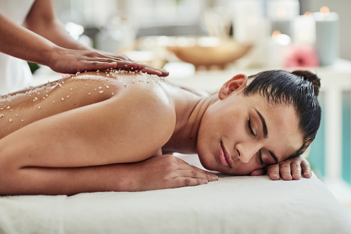 Spa, woman and hands with salt massage on back for physical therapy, wellness or aromatherapy with relax. Masseuse, luxury service or body care for peace, stress relief and skincare in hotel with zen