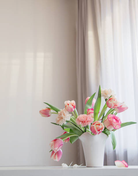istock pink spring flowers in white ceramic vase in modern home interior 1939533706