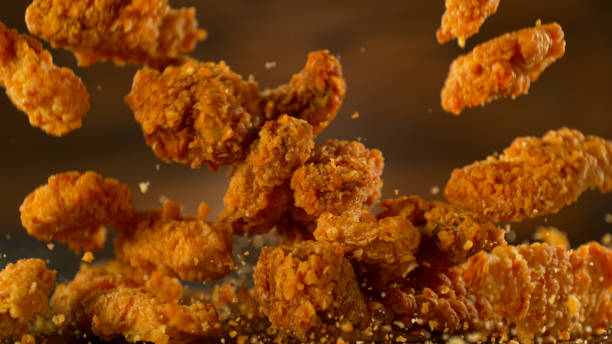 istock Falling tasty fried chicken wings or strips 1939547885
