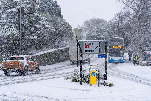 Vehicles struggling on hill due to snow fall