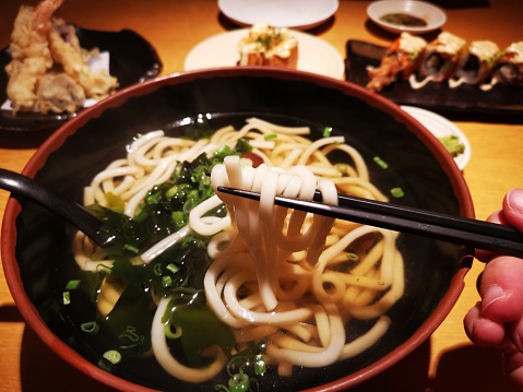 Focus scene on Japanese food - Soup Tempura Udon in restaurant