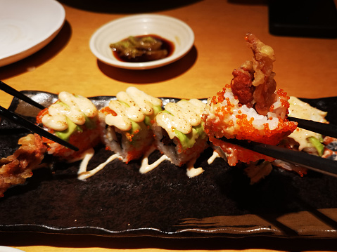Focus scene on Japanese food - Mentaiko Spider Roll in restaurant