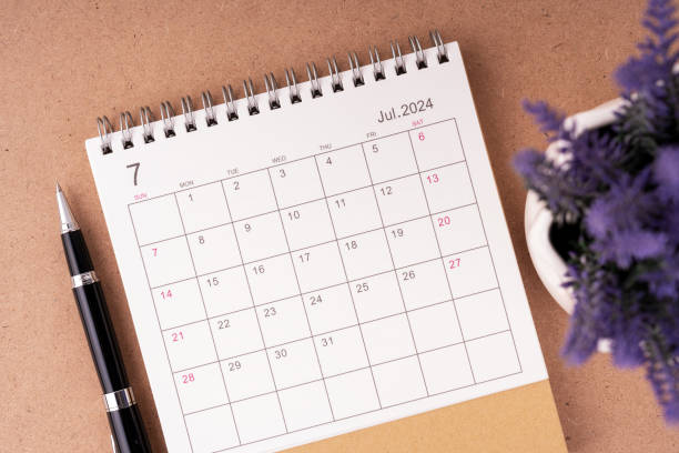 istock July 2024 desk calendar flat lay 1939560660