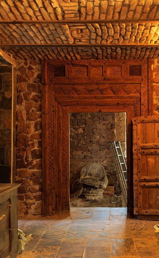 carved wooden casing in the basement of an old house. Repairs inside the castle
