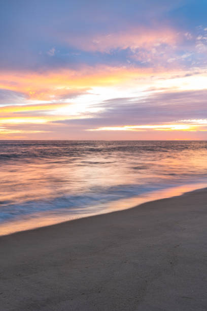 istock Cloudscape and seascape at ocean sunset with sandy beach in Portugal 1939567731