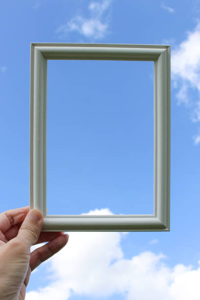 istock Hand holding blank wooden picture frame 1939579775