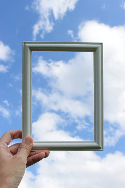 istock Hand holding blank wooden picture frame 1939579784