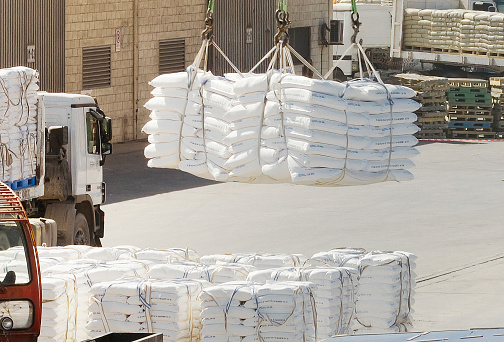 10/21/2014 - Oman: Crane lifting stacked sacks in an industrial area