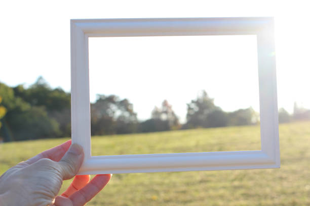 Hand holding blank wooden picture frame