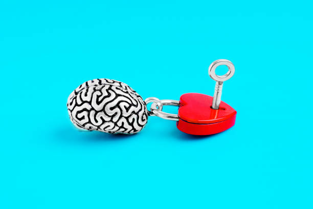 istock Human Brain and Heart-Shaped Padlock with Key on Blue Background