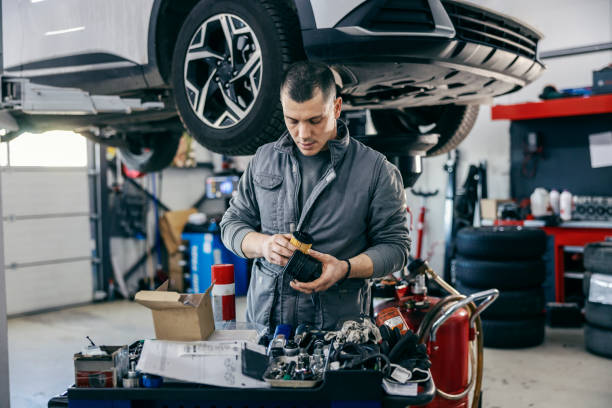 istock A mechanic is working with engine parts and fixing it while standing at the mechanic's shop. 1939638738