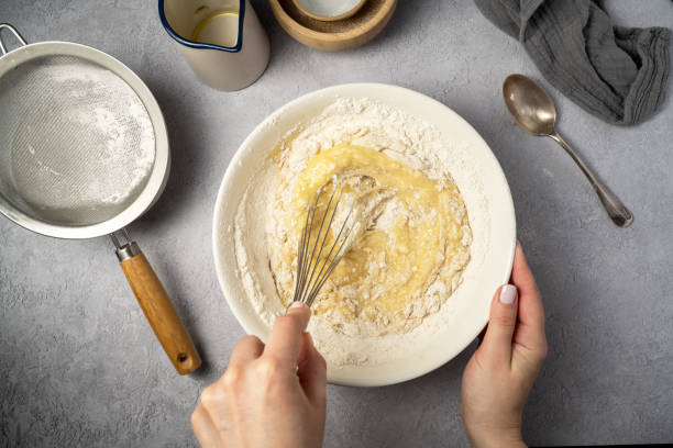 istock Cooking a cake or dessert pastry. Mixing raw dough and ingredients for baking. 1939673995