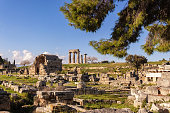 View of the ruins of Ancient Corinth and the temple of Apollo at background. Corinth, Greece