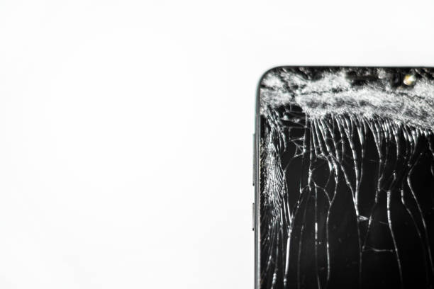 Mobile phone with broken screen on white background.Closeup.Copy space.