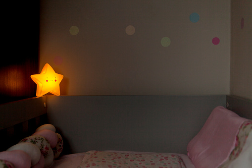 Baby crib with star lamp. Luminaire star concept. Baby crib concept.