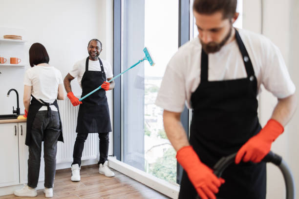 istock Focus on positive African American worker cleaning panoramic window. 1939715476