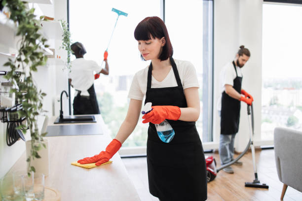istock Housekeeper team in uniform apron cleaning service team at home 1939716595