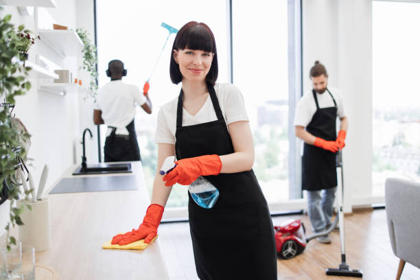 istock Caucasian janitor in apron cleaning table . 1939717141