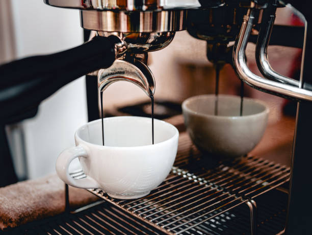 istock Coffee extraction from the coffee machine with a portafilter pouring coffee into a cup,Espresso poruing from coffee machine at coffee shop 1939720615