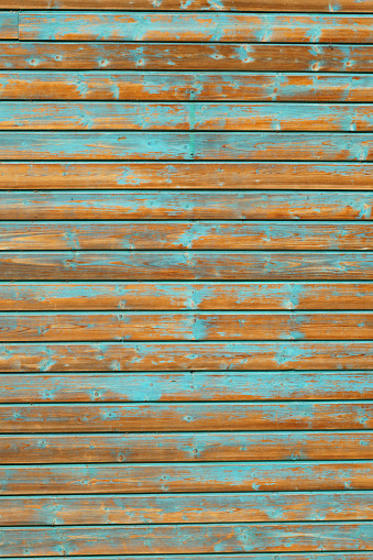 Vintage wooden background with peeling blue paint. Vertical frame.