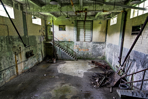 Old broken empty abandoned industrial building interior.