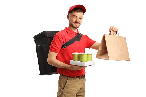 Food delivery man holding takeaway food and coffee isolated on white background