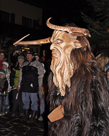 Unidentified man wears Krampus (devil) mask at traditional procession on December in Thumersbach, Austria on December 4, 2006