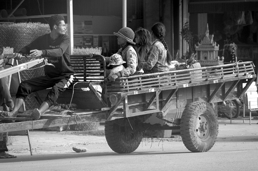 Cambodian family riding on two-wheeled tractor in Siem Reap province, Cambodia.