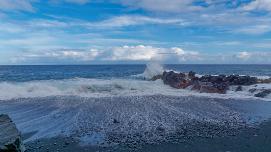 Waves crashing at rocks at Pohoiki black sand beach, Isaac Hale Park on the Big Island of Hawaii