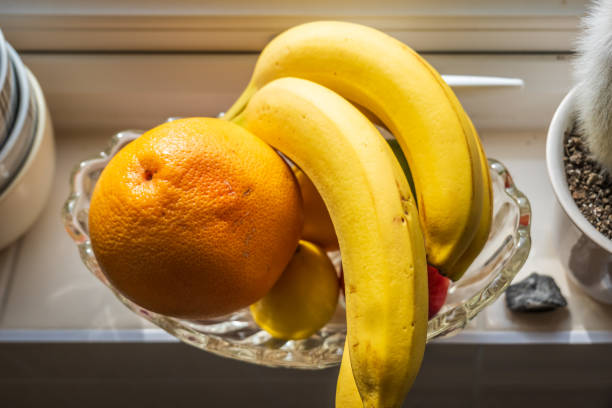 Fresh ripe banana fruit on kitchen windowsill.