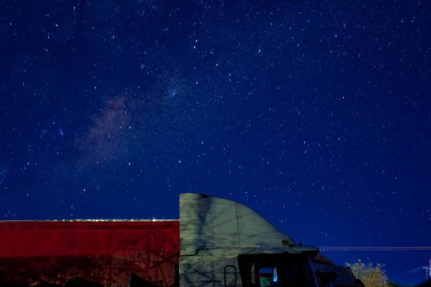 A long haul truck in the night under the stars